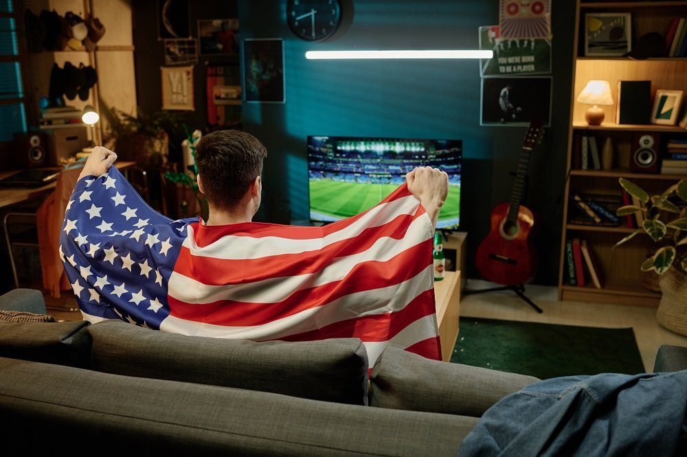 unrecognizable fan watching football match